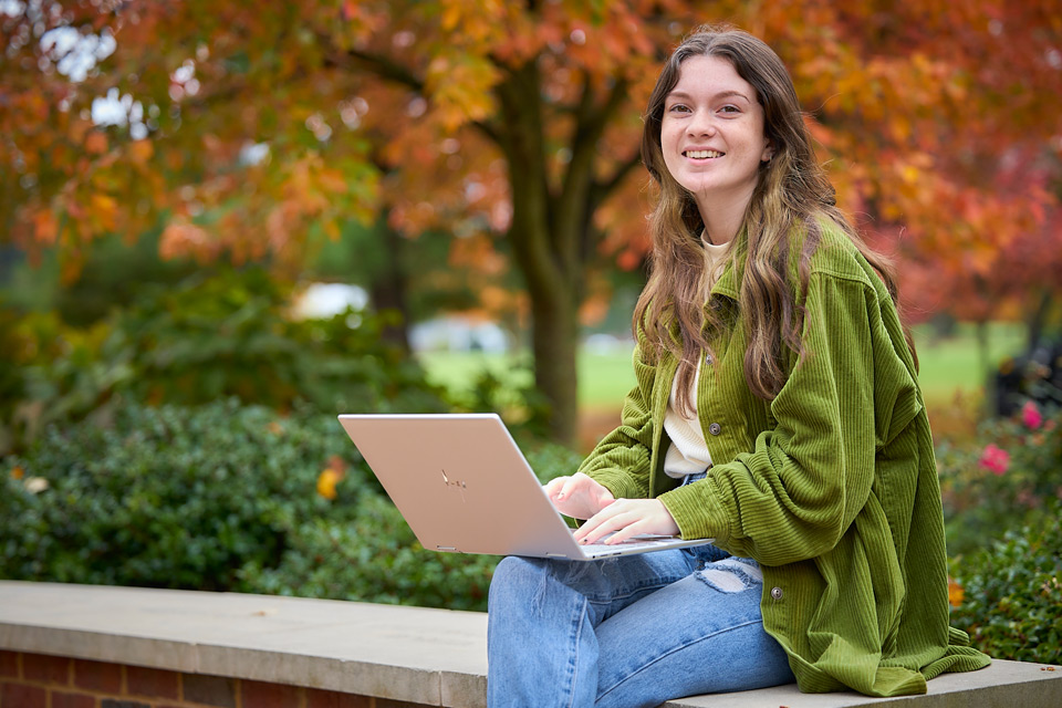 Student sitting and typing