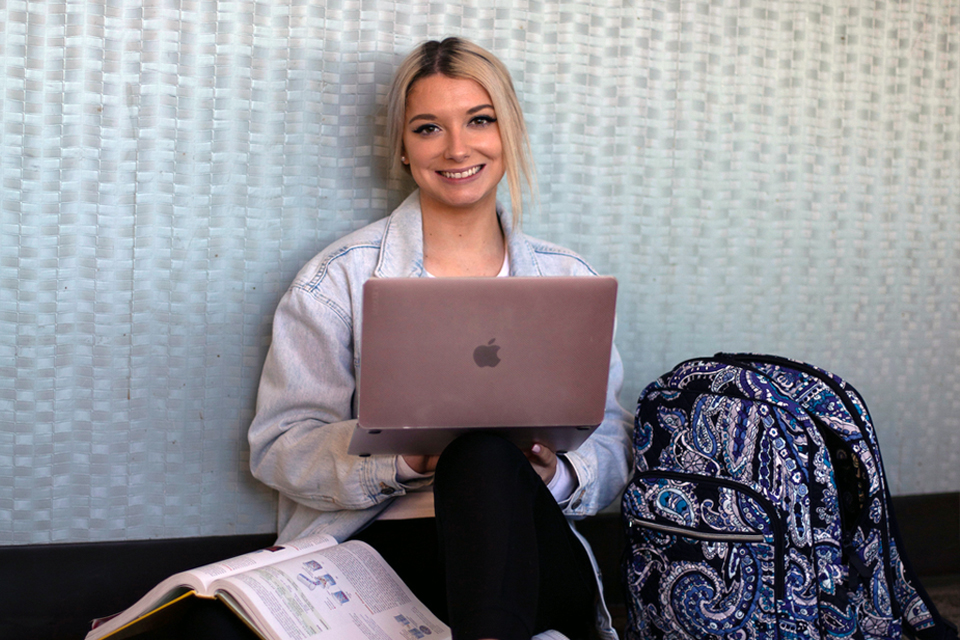 Student with laptop on campus